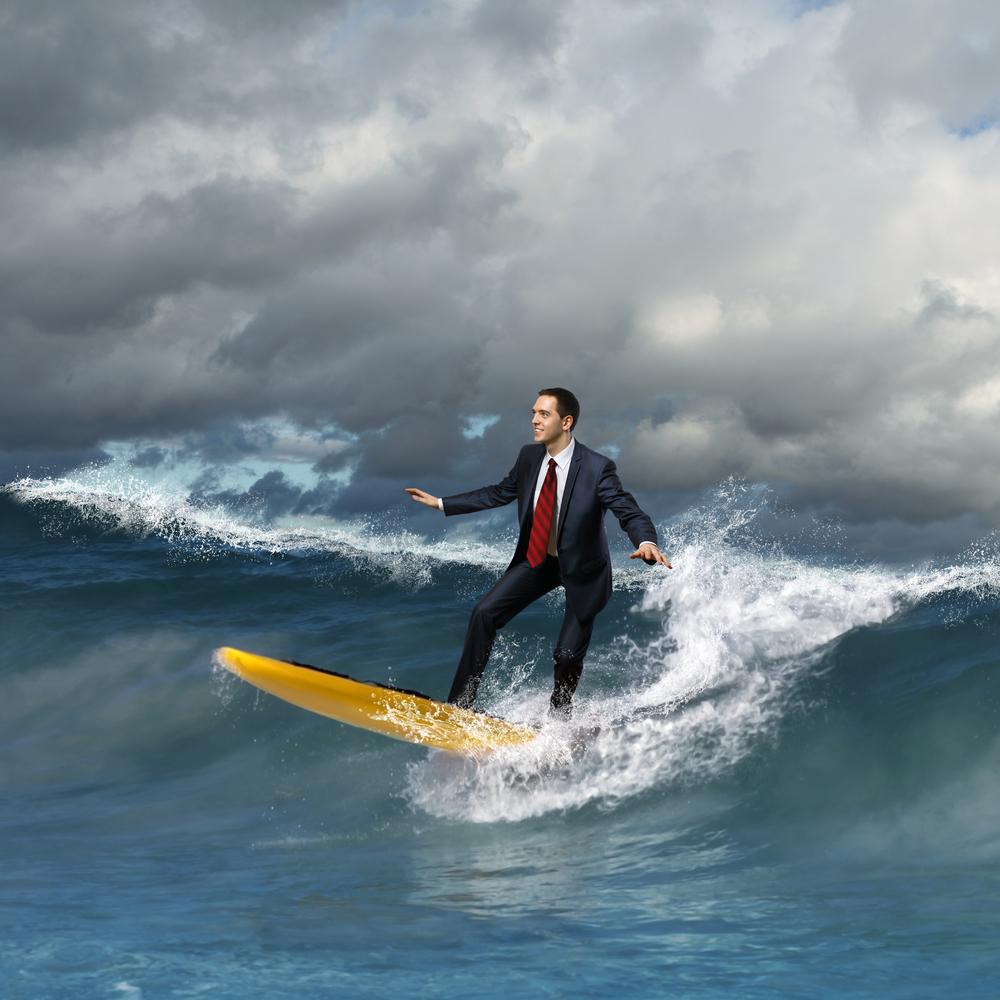 business person surfing a wave